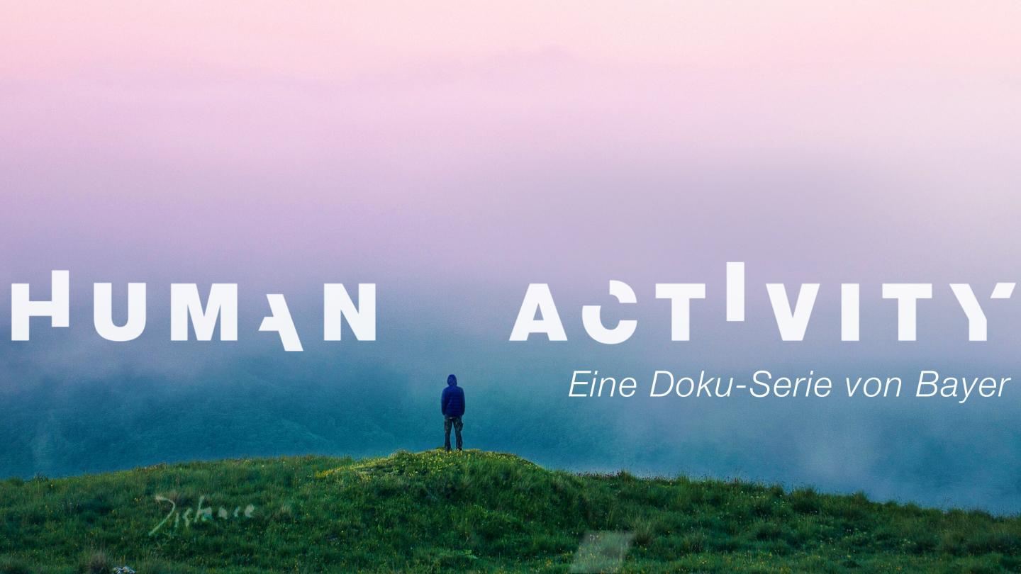 Person standing on a hill in the distance with sunset in background. Words over top of image read Human Activity