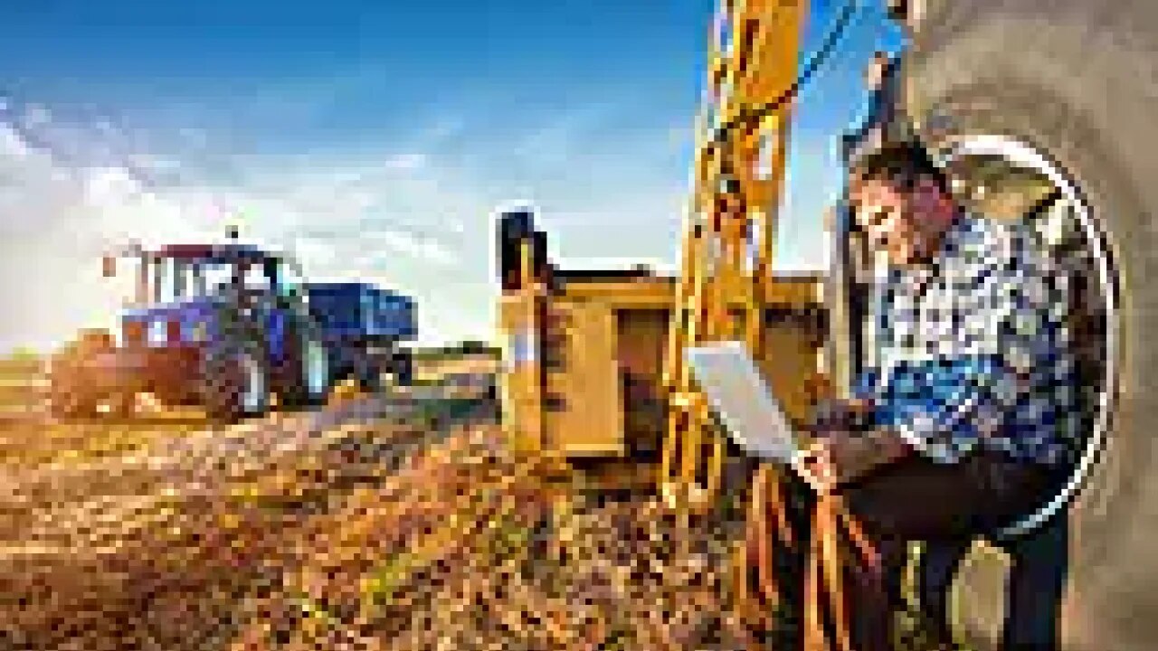 farmer on field with laptop