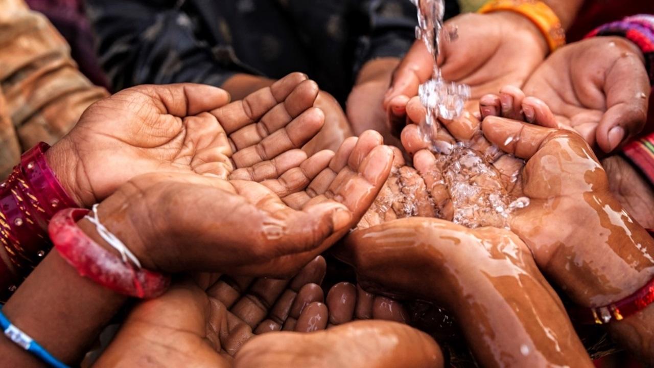 Hands reaching water 